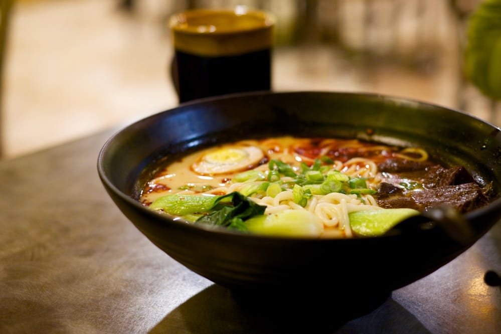 A steaming bowl of noodle soup with bok choy at P P Pop